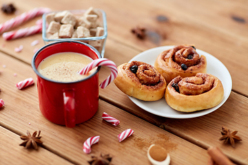 Image showing eggnog with candy cane in cup and cinnamon buns