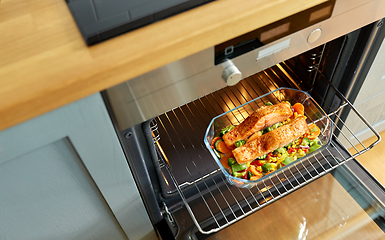 Image showing food cooking in baking dish in oven at home