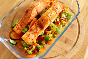 Image showing salmon fish in baking dish on kitchen table