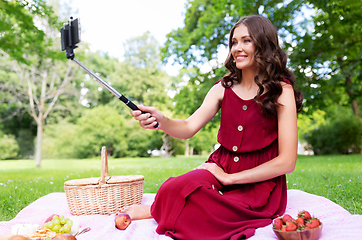 Image showing happy woman with smartphone taking selfie at park