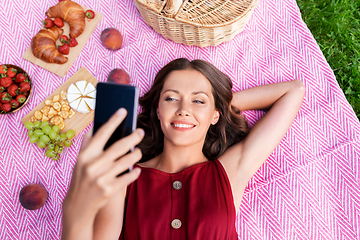 Image showing happy woman with smartphone taking selfie at park