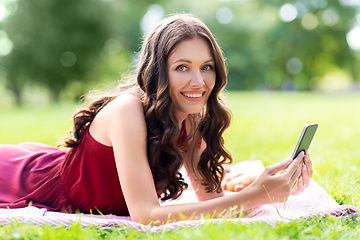 Image showing happy woman with smartphone at park