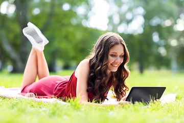 Image showing happy woman with tablet computer on picnic at park