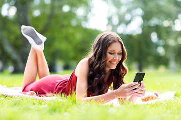 Image showing happy woman with smartphone at park