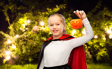 Image showing girl in halloween costume of dracula with pumpkin