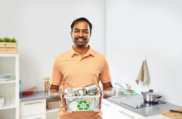 Image showing smiling young indian man sorting metallic waste