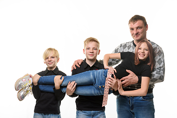 Image showing Dad and two sons holding a teenage girl in their arms, casual wear in dark colors, white background