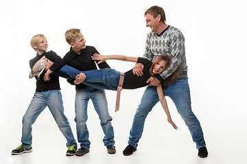 Image showing Dad and sons stretch sister by the arms and legs, white background