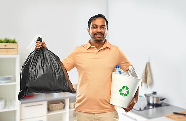 Image showing smiling indian man sorting paper and plastic waste