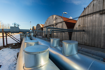 Image showing outdoor pipeline and old hangars in winter