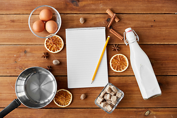 Image showing notebook, pencil, ingredients for eggnog cooking