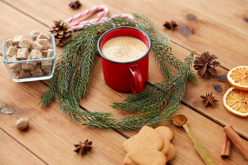 Image showing cup of eggnog, fir branches, gingerbread and sugar