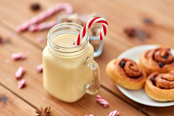 Image showing eggnog with candy cane in mug and cinnamon buns