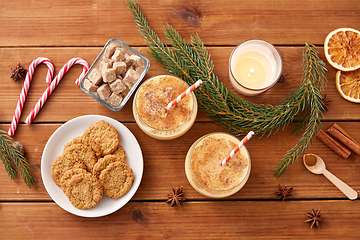 Image showing glasses of eggnog, oatmeal cookies and fir branch