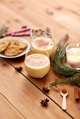 Image showing glasses of eggnog, oatmeal cookies and fir branch