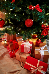 Image showing gift boxes under decorated christmas tree at home