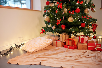 Image showing gift boxes under decorated christmas tree at home