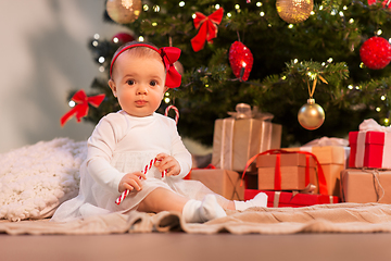 Image showing baby girl at christmas tree with gifts at home