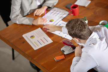 Image showing Front view colleagues working together in a office using modern devices and gadgets during creative meeting