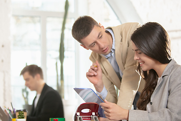 Image showing Side view colleagues working together in a office using modern devices and gadgets during creative meeting