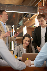 Image showing Front view colleagues working together in a office using modern devices and gadgets during creative meeting