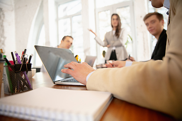 Image showing Side view colleagues working together in a office using modern devices and gadgets during creative meeting