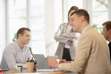 Image showing Side view colleagues working together in a office using modern devices and gadgets during creative meeting