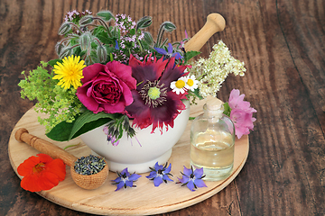 Image showing Essential Oil Preparation with Fresh Herbs and Flowers