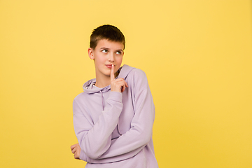 Image showing Caucasian girl\'s portrait isolated on yellow studio background with copyspace