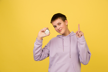 Image showing Caucasian girl\'s portrait isolated on yellow studio background with copyspace