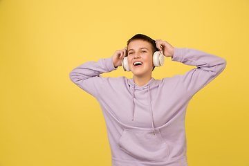 Image showing Caucasian girl\'s portrait isolated on yellow studio background with copyspace