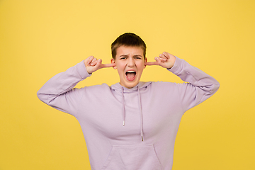 Image showing Caucasian girl\'s portrait isolated on yellow studio background with copyspace