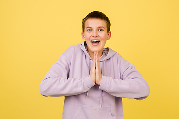 Image showing Caucasian girl\'s portrait isolated on yellow studio background with copyspace