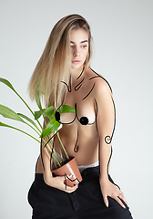 Image showing Young blonde beautiful naked woman with line art drawing illustration on body