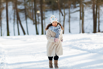 Image showing happy little girl running at winter park