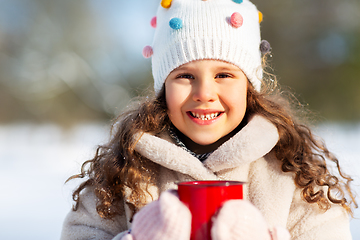 Image showing little girl with cup of hot tea in winter park