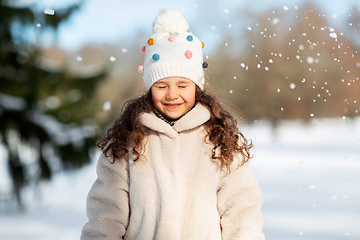 Image showing happy little girl in winter clothes outdoors