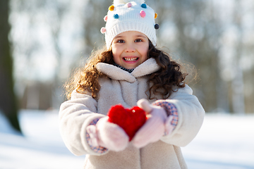 Image showing happy little girl with heart outdoors in winter