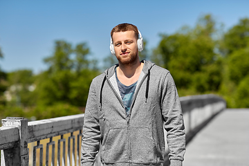 Image showing man in headphones listening to music outdoors