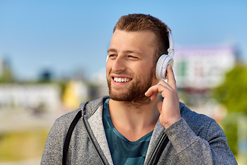 Image showing man in headphones listening to music outdoors