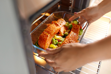 Image showing woman cooking food in oven at home kitchen