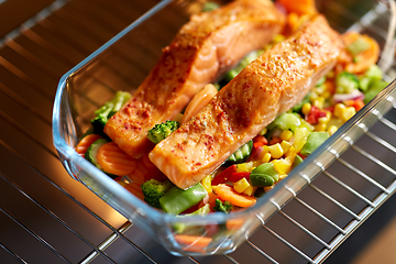 Image showing food cooking in baking dish in oven at home