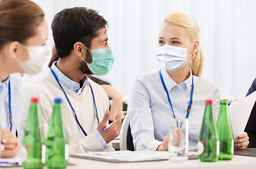 Image showing business people in masks at meeting or conference