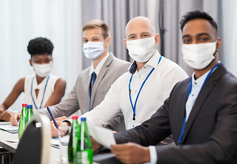 Image showing business people in masks at meeting or conference