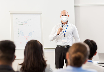 Image showing businessman in mask at business conference