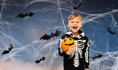 Image showing happy boy in halloween costume with jack-o-lantern