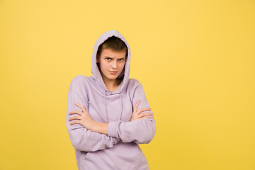 Image showing Caucasian girl\'s portrait isolated on yellow studio background with copyspace