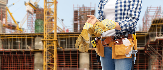 Image showing woman or builder with gloves and working tools