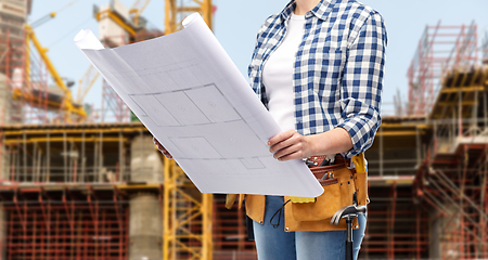 Image showing female builder with blueprint and working tools