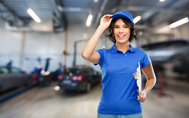 Image showing female worker with clipboard at car service